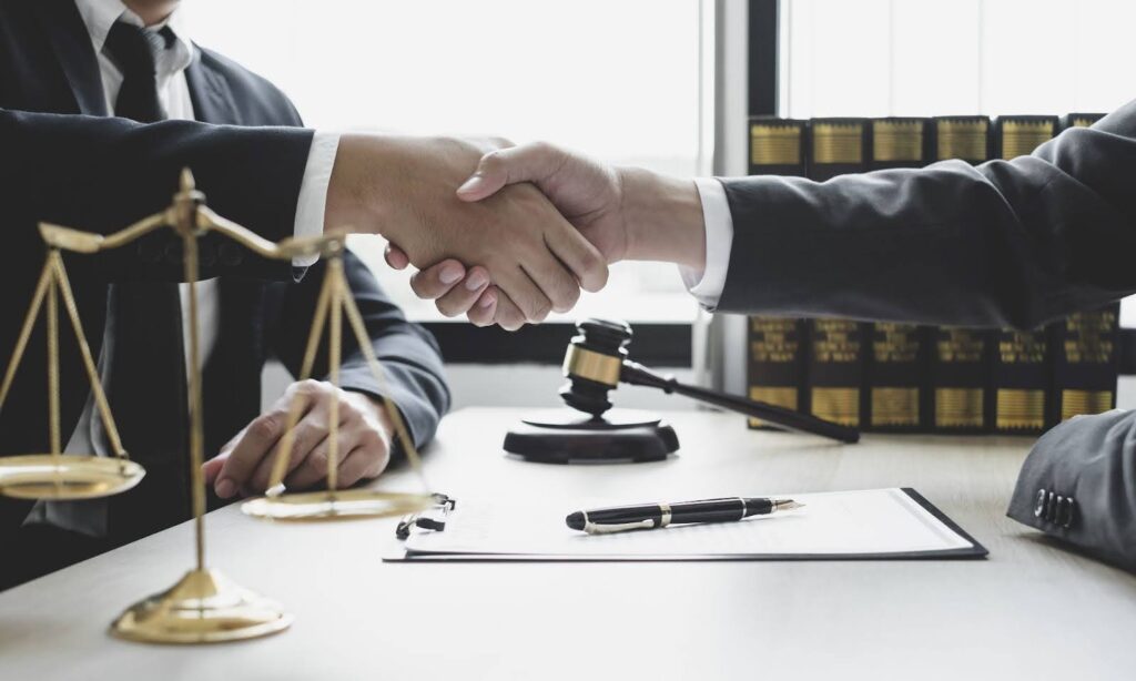 A lawyer working with a client to defend their California trust beneficiary rights.