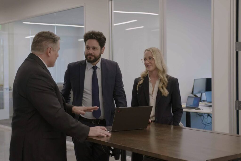 The Gokal team at a table in their office going over examples of executor misconduct.