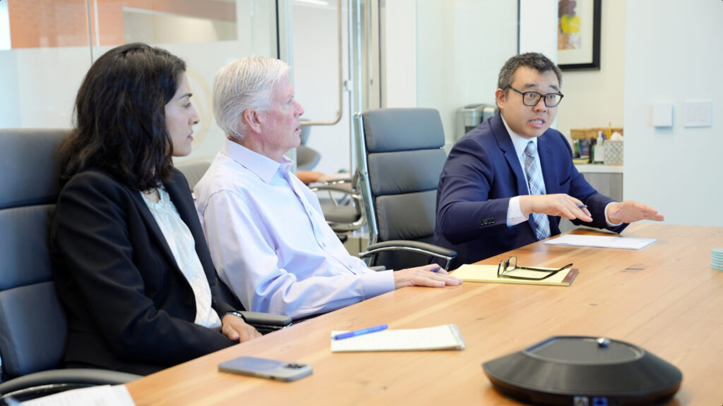 Andrew speaking to the Gokal Law Group team at a conference table about a case that revolves around the question, Can a power of attorney transfer money to themselves?